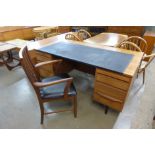 A teak and black vinyl topped desk and chair