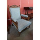 A Victorian carved oak and fabric upholstered armchair