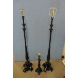 A pair of black standard lamps and matching table lamp