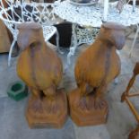 A pair of large cast iron garden figures of eagles