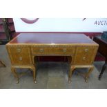 A George I style inlaid walnut and red leather topped writing table