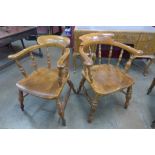 A pair of similar Victorian elm and beech smokers bow chairs