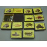 A collection of matchboxes decorated with armoured tanks and a Japanese lighter