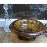 A cut glass decanter with silver top and an amber bowl with stand