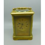 A brass and four glass sided French mantel timepiece