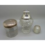 A silver topped match striker, a silver topped glass jar and a silver mounted scent bottle lacking