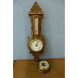 Two early 20th Century carved oak aneroid barometers