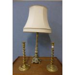 A brass table lamp and a pair of brass barleytwist candlesticks