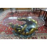 A French style brass effect hand shaped coffee table with oval glass top