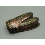 A Japanese Cicada brass and copper ink cartridge