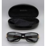 A pair of Gucci sunglasses