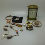 A carriage clock and a bag of costume jewellery