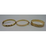 Three 9ct gold/metal core bangles