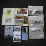 An album of greetings cards, four black and white military photographs, an album of Army photographs