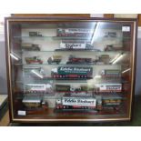 A display cabinet with die-cast model Eddie Stobart lorries and other vehicles (approximately 21)