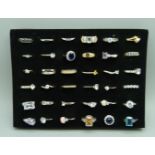 A tray of thirty-six costume rings