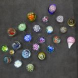 Twenty-four assorted glass paperweights