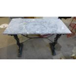 A cast iron based and marble topped garden table