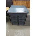 A vintage industrial steel engineer's chest with painted wooden top