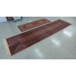 Two red ground rugs, 360 x 90cms and 200 x 67cms