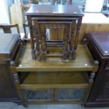 A carved oak trolley and a nest of tables