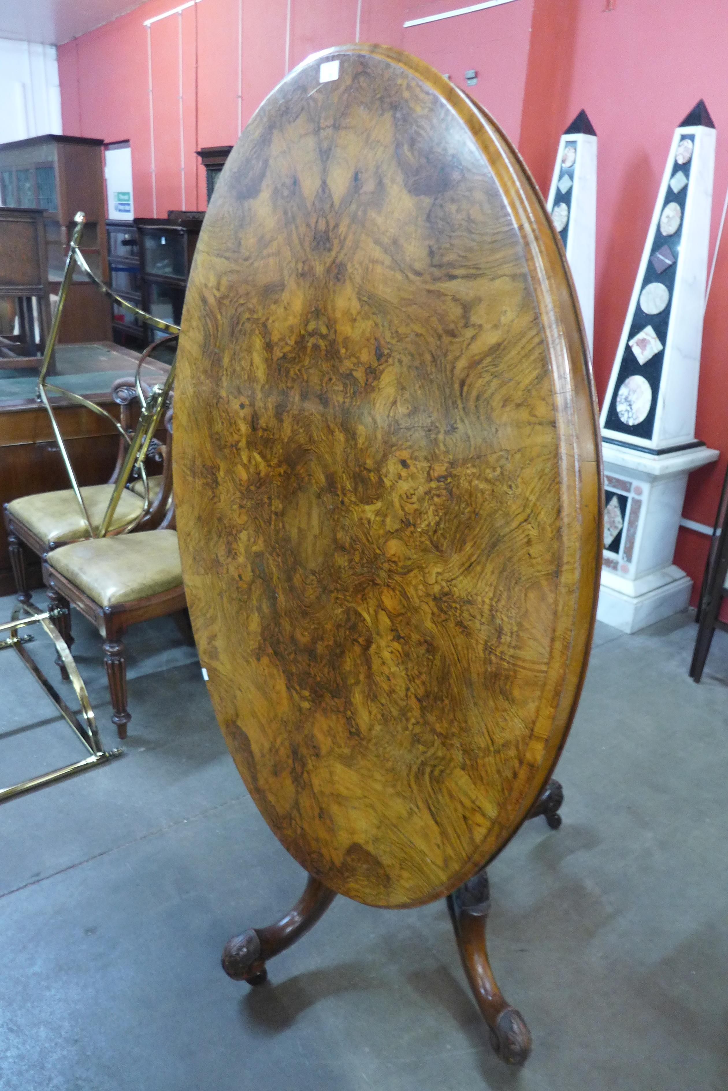 A Victorian figured walnut oval tilt-top centre table