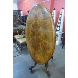 A Victorian figured walnut oval tilt-top centre table