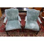 A pair of Carolean style carved walnut and fabric upholstered open armchairs