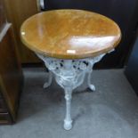 A painted cast iron based circular pub table