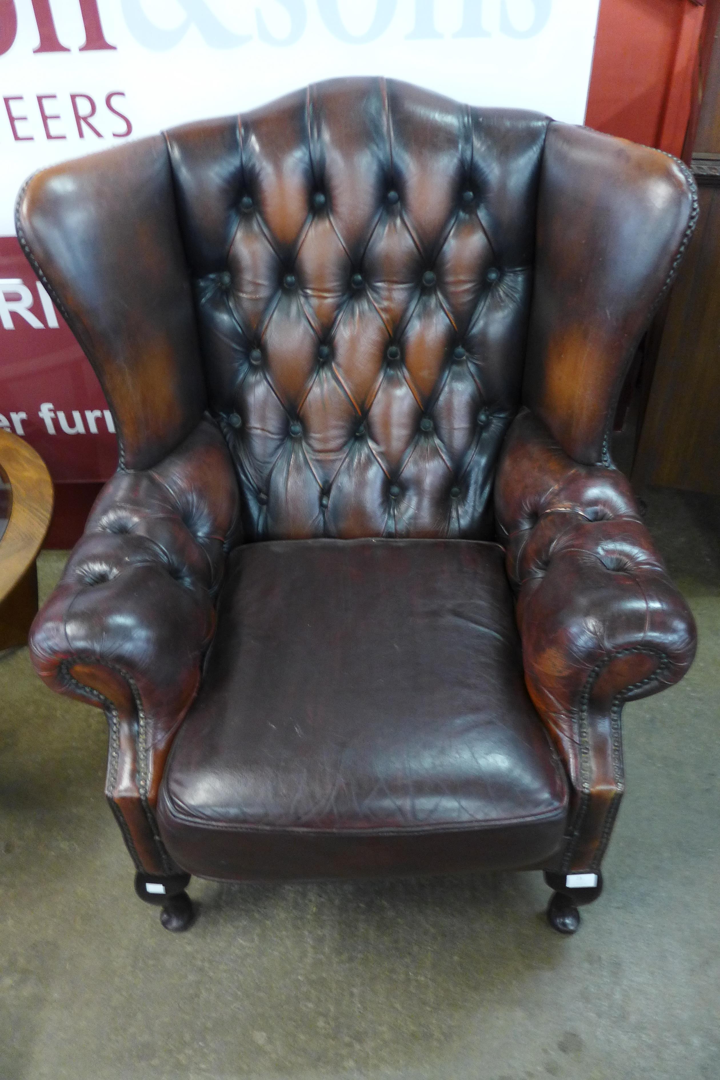 A mahogany and chestnut brown leather Chesterfield wingback armchair - Image 2 of 2