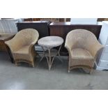 A pair of wicker armchairs and table