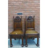 A pair of Victorian Gothic Revival oak hall chairs, manner of A.W.N. Pugin