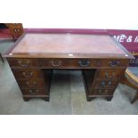A George III style mahogany and red leather topped pedestal desk