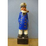 A vintage painted wooden figure of a sailor