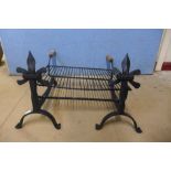 A pair of French wrought iron andirons and a grill