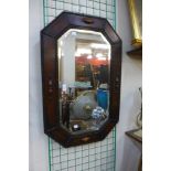An early 20th Century oak framed octagonal mirror