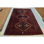 An eastern hand knotted red ground Shiraz rug, 260 x 170cms