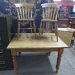 A pine kitchen table and two beech chairs