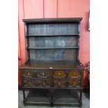 A Jacobean Revival oak geometric moulded dresser