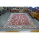 A hand knotted Persian red ground Tabriz rug, 398 x 297cms