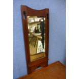 An Arts and Crafts walnut framed hall mirror