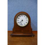 An early 20th Century inlaid oak timepiece