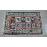 An eastern red ground prayer rug, 150 x 94cms