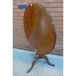 A George III mahogany circular tilt-top birdcage action tripod tea table