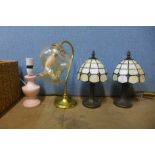 A pair of Tiffany style table lamps, another lamp and a cane basket