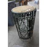 A wicker and wrought steel wine rack