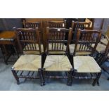 A set of six Georg III style elm and ash spindle back rush seated chairs