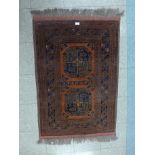 An eastern terracotta ground rug, 120 x 83cms