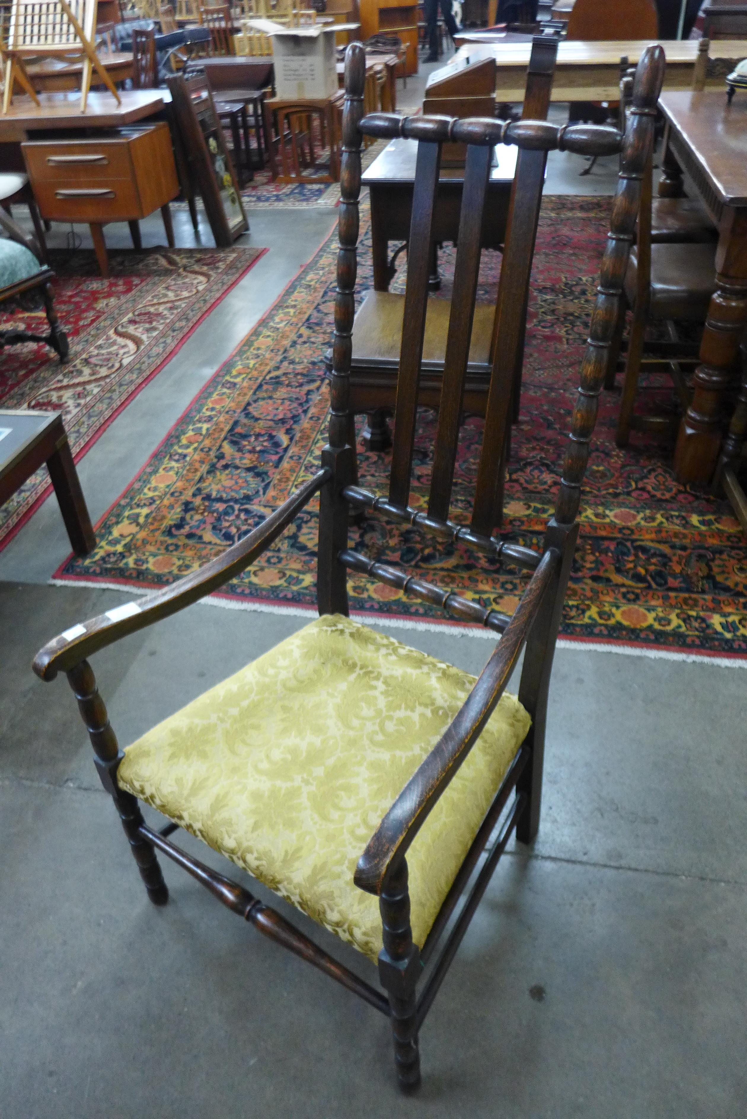 An Arts and Crafts oak fireside chair