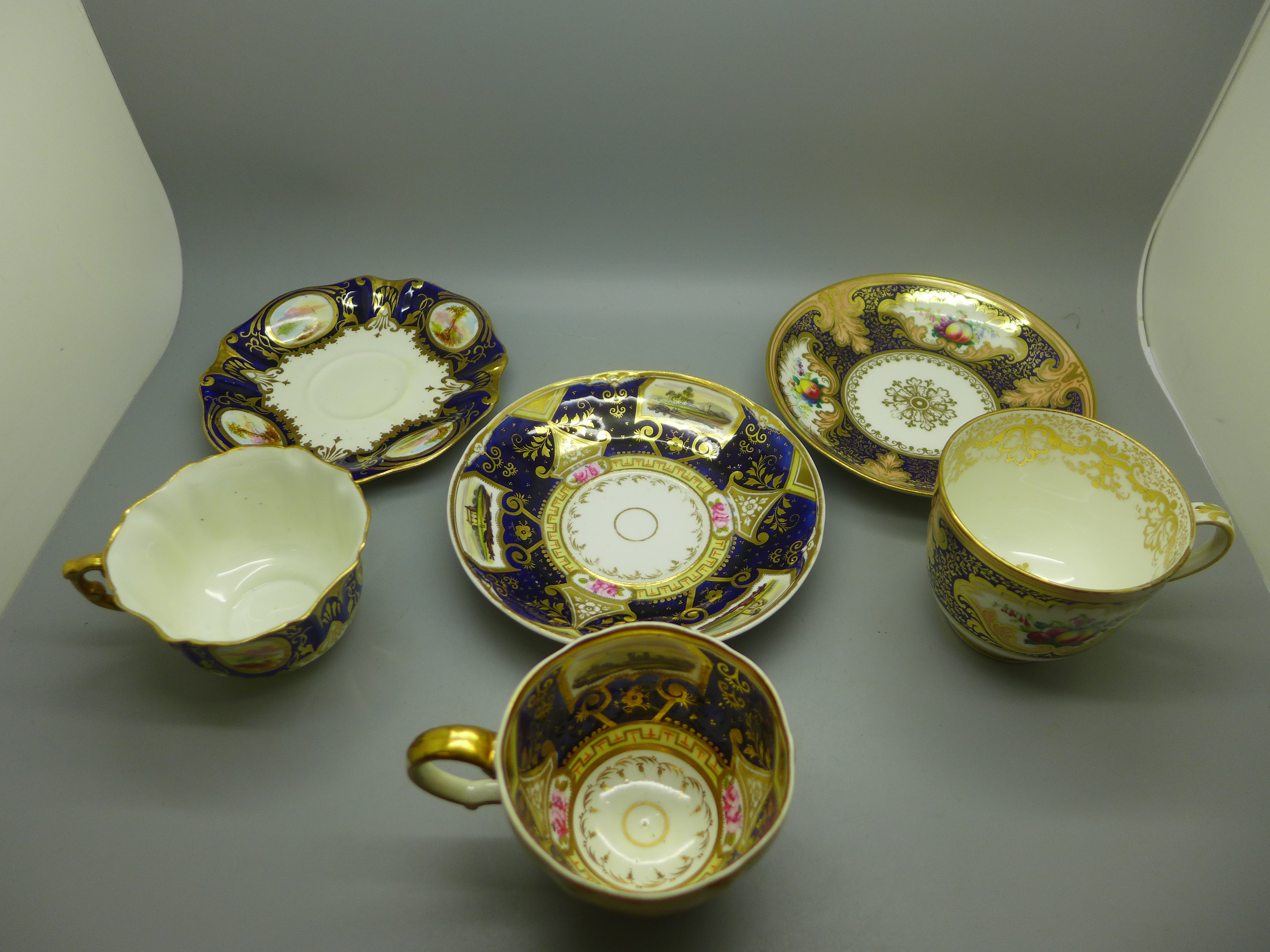 Three 18th/19th Century cups and saucers, two with painted panels of landscapes, one decorated - Image 2 of 2